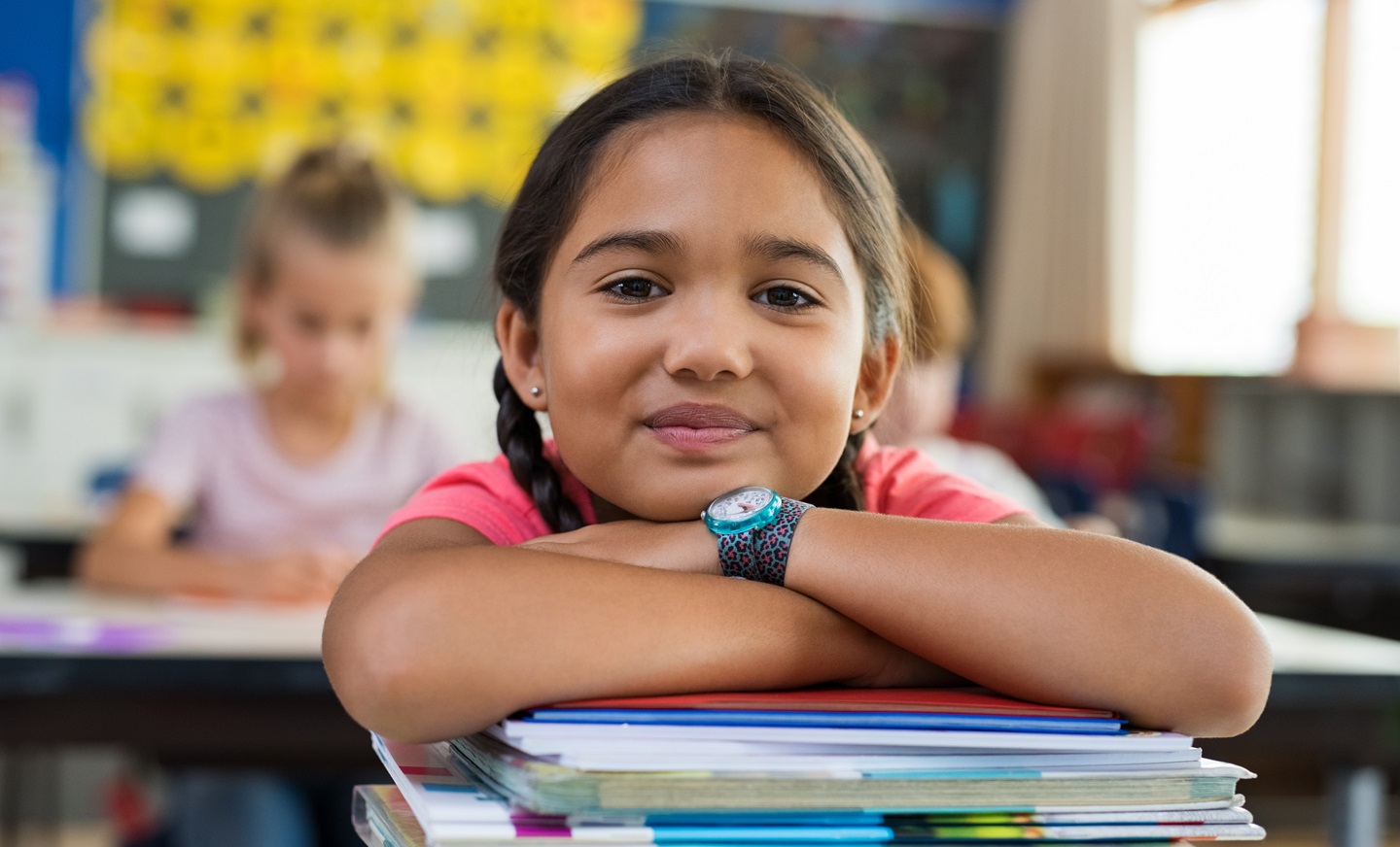 Bambina soddisfatta con libri a scuola